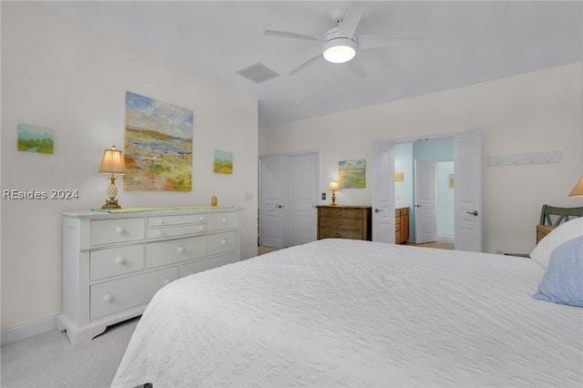 bedroom with light carpet, ceiling fan, and a closet