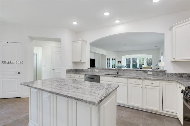 kitchen featuring sink, dishwasher, a center island, white cabinets, and kitchen peninsula