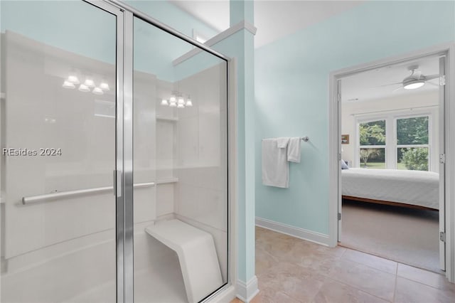 bathroom with an enclosed shower and tile patterned floors