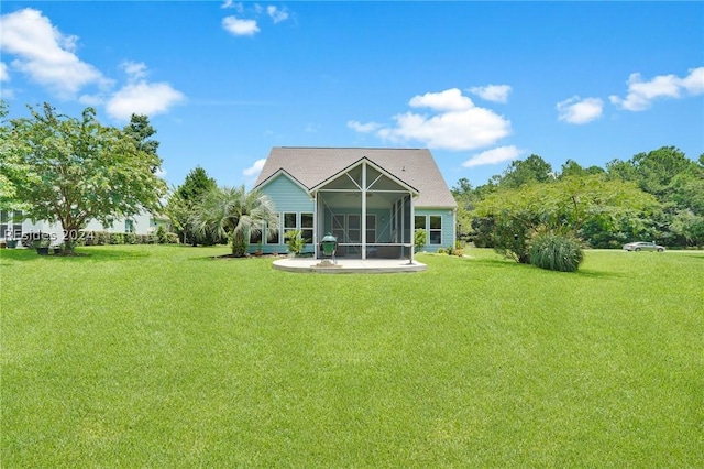 back of property featuring a yard, glass enclosure, and a patio area