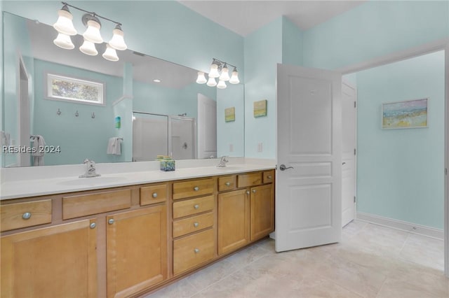 bathroom with vanity and a shower with shower door