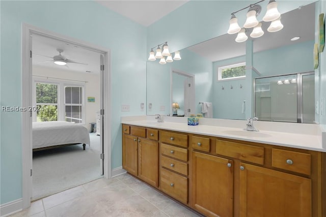 bathroom featuring ceiling fan, vanity, a shower with shower door, and a wealth of natural light