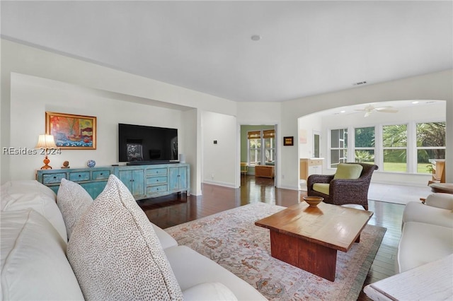 living room with dark hardwood / wood-style floors and ceiling fan