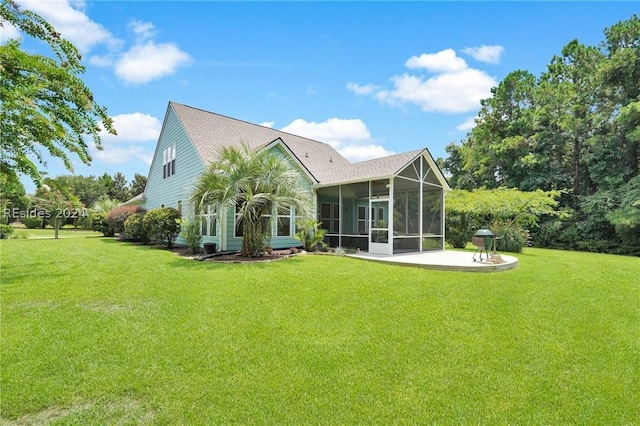 rear view of property featuring a sunroom, a yard, and a patio area