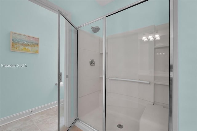 bathroom featuring tile patterned floors and a shower with door