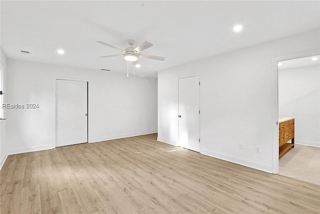 spare room with light hardwood / wood-style flooring and ceiling fan