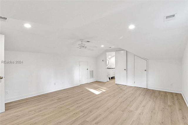 bonus room featuring ceiling fan, vaulted ceiling, and light wood-type flooring