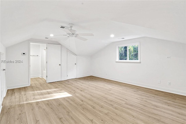 additional living space with ceiling fan, lofted ceiling, and light wood-type flooring