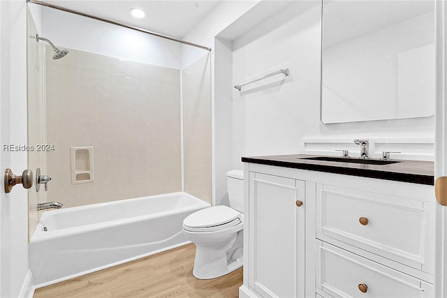 full bathroom with vanity, hardwood / wood-style floors, toilet, and washtub / shower combination