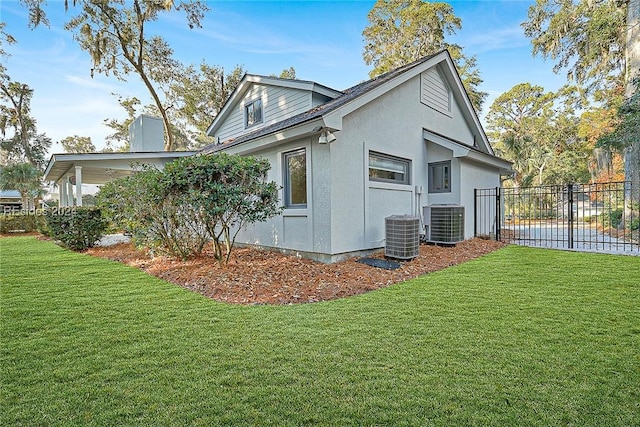 view of property exterior featuring a yard and central AC