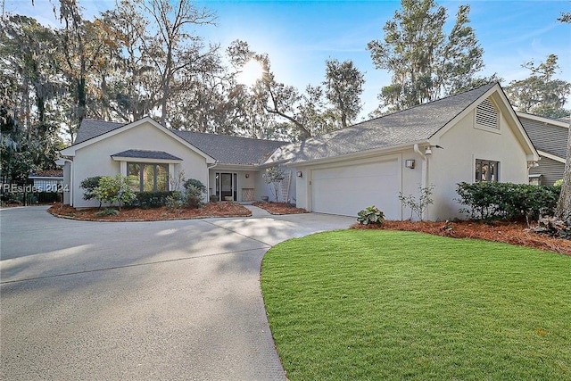 ranch-style home featuring a garage and a front lawn