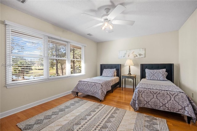 bedroom featuring hardwood / wood-style flooring and ceiling fan