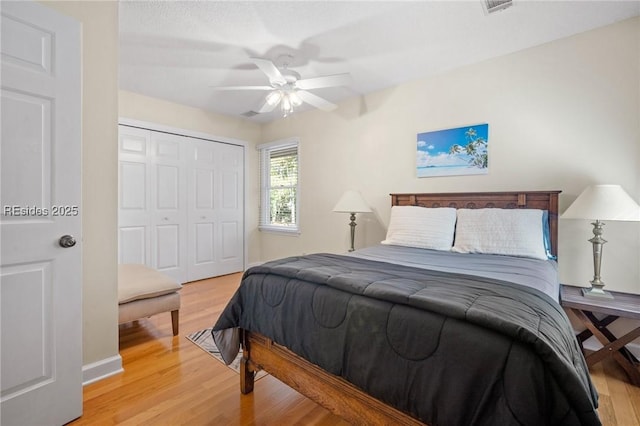 bedroom with ceiling fan, hardwood / wood-style floors, and a closet