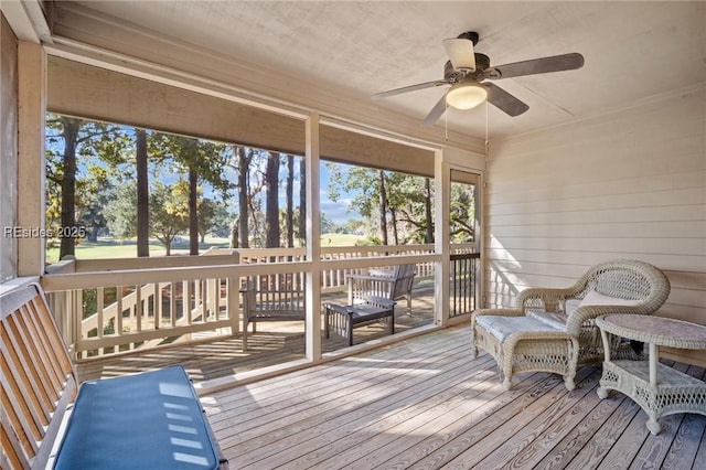 sunroom / solarium featuring ceiling fan