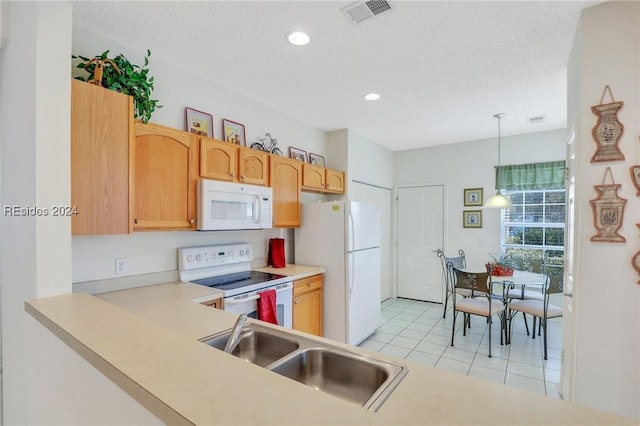 kitchen featuring light tile patterned floors, white appliances, hanging light fixtures, a textured ceiling, and light brown cabinetry