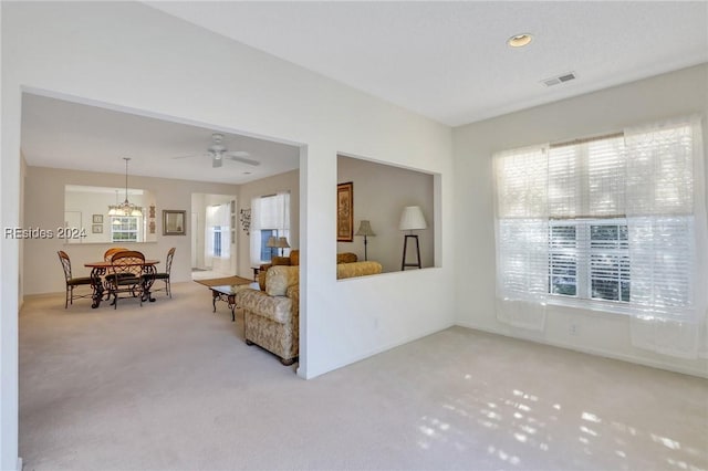 carpeted living room featuring a wealth of natural light and ceiling fan