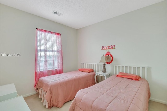 carpeted bedroom featuring a textured ceiling