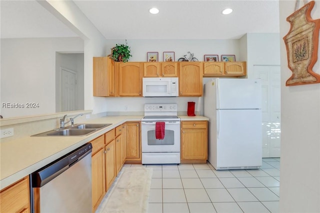 kitchen with white appliances, sink, light brown cabinets, and light tile patterned floors