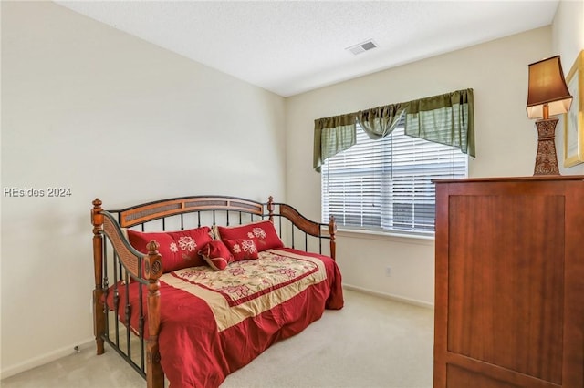 bedroom with light colored carpet