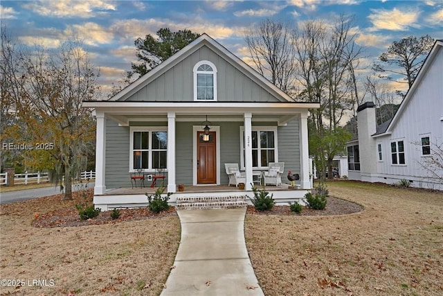 bungalow with a yard and covered porch