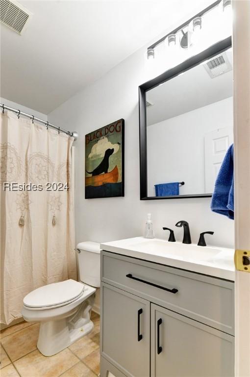 bathroom with tile patterned flooring, vanity, and toilet