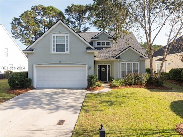 view of property featuring a garage and a front yard