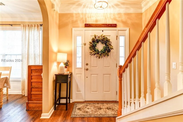 entryway featuring hardwood / wood-style flooring, ornamental molding, and a healthy amount of sunlight