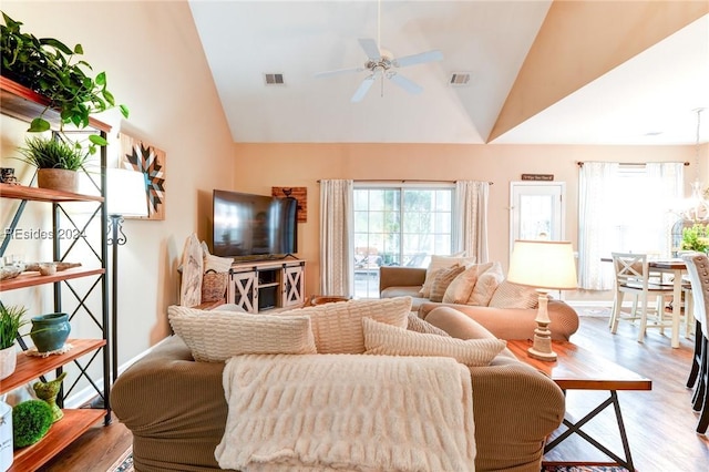 living room featuring high vaulted ceiling, light hardwood / wood-style floors, and ceiling fan