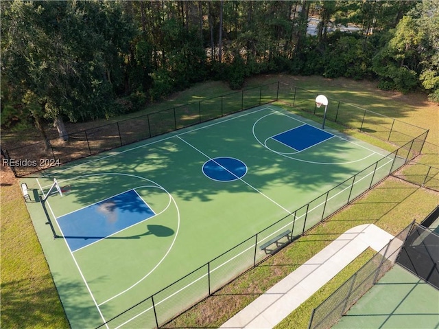 view of basketball court with a lawn