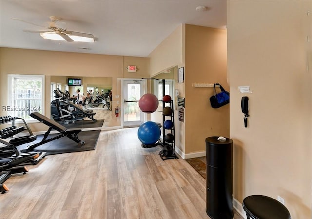 gym with ceiling fan and light wood-type flooring