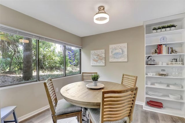 dining space featuring wood-type flooring