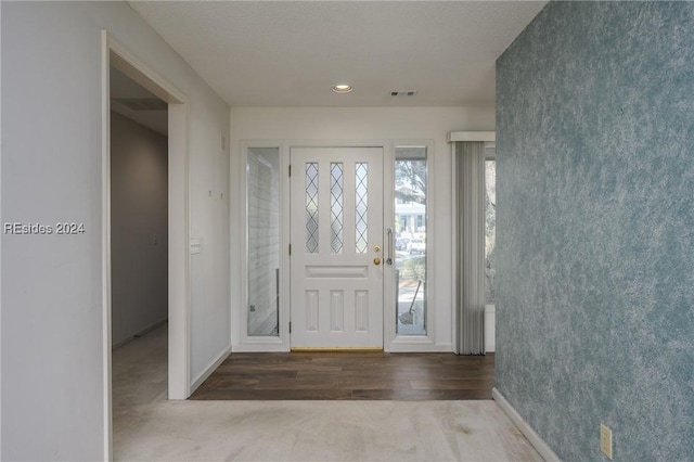 view of carpeted foyer entrance