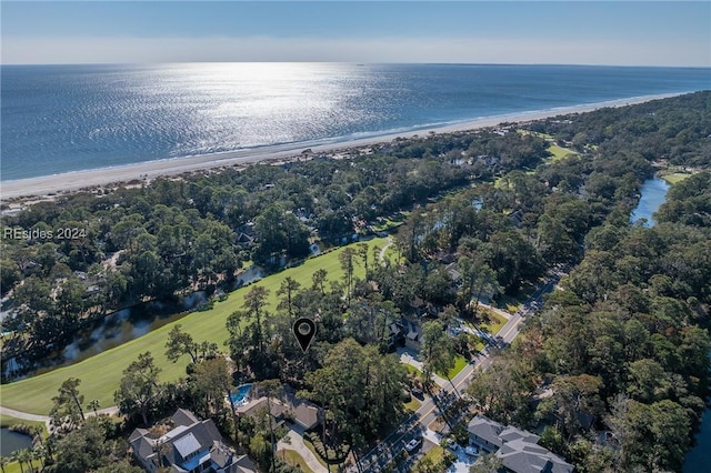 drone / aerial view featuring a beach view and a water view