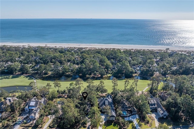 birds eye view of property featuring a water view and a beach view