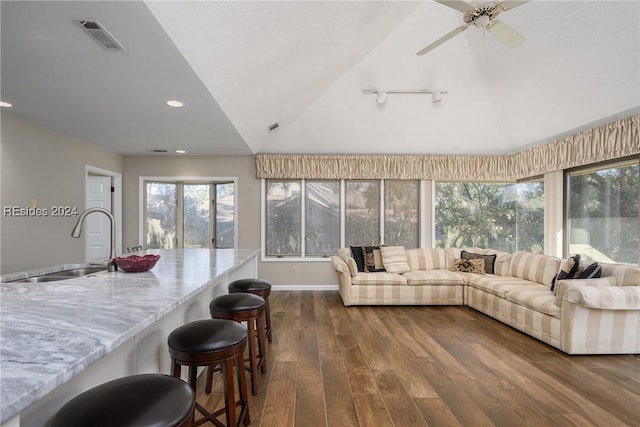 living room with ceiling fan, lofted ceiling, dark hardwood / wood-style floors, and sink