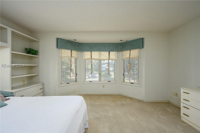 bedroom featuring light colored carpet