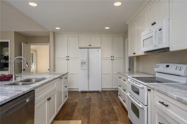 kitchen featuring sink, white appliances, dark wood-type flooring, white cabinetry, and light stone countertops