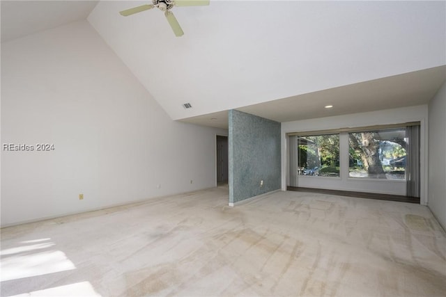 unfurnished living room featuring ceiling fan, light carpet, and high vaulted ceiling