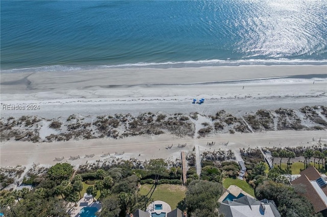 bird's eye view with a water view and a beach view