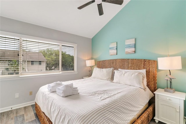 bedroom featuring ceiling fan, lofted ceiling, and light wood-type flooring