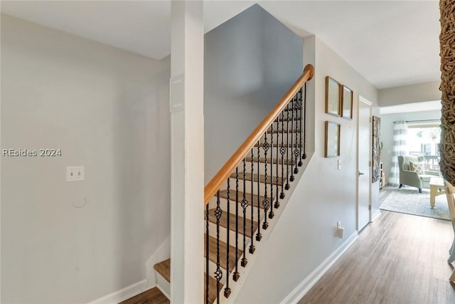 stairway with hardwood / wood-style flooring