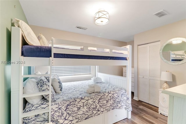 bedroom with light wood-type flooring and a closet