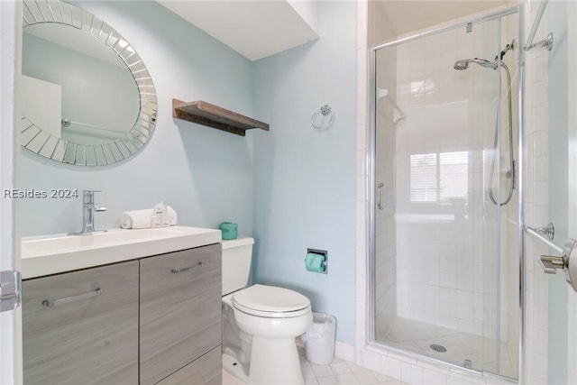 bathroom with vanity, tile patterned floors, toilet, and walk in shower