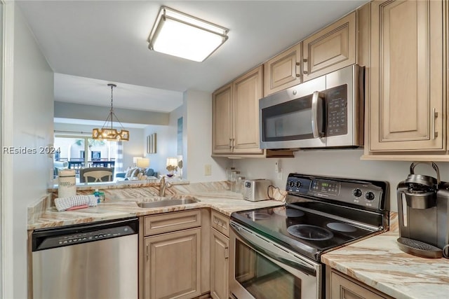 kitchen featuring appliances with stainless steel finishes, sink, and light brown cabinets