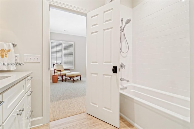 bathroom featuring vanity, wood-type flooring, and  shower combination