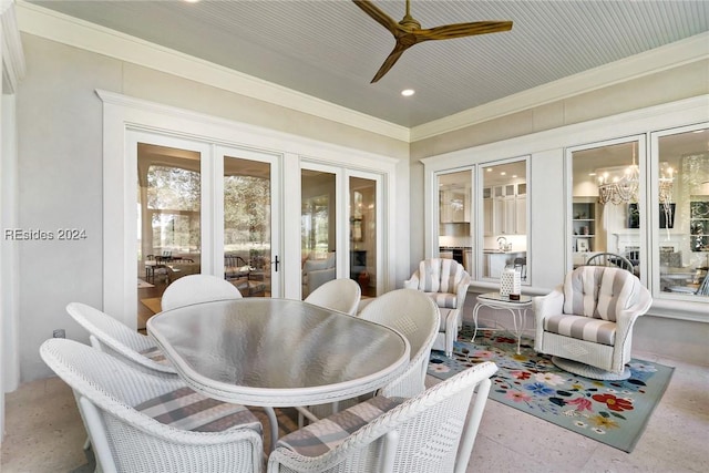 sunroom / solarium with ceiling fan with notable chandelier