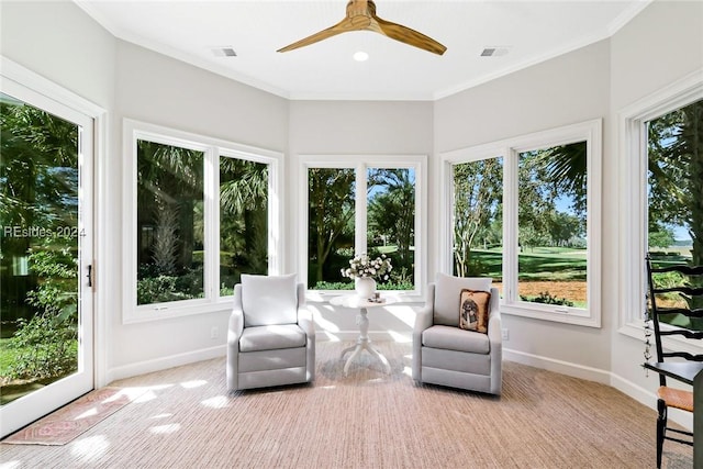 unfurnished sunroom featuring ceiling fan and a healthy amount of sunlight