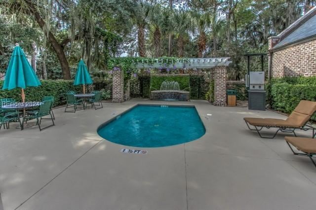 view of swimming pool featuring a pergola and a patio area