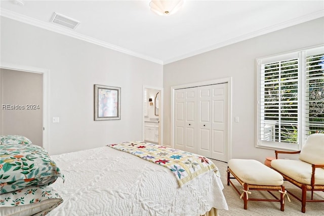 bedroom featuring crown molding, connected bathroom, and a closet