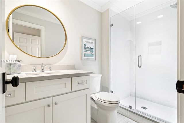 bathroom featuring crown molding, a shower with shower door, vanity, and toilet